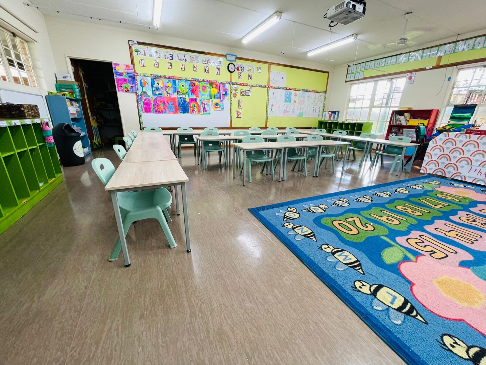 Empty classroom with rows of wooden desks and chairs